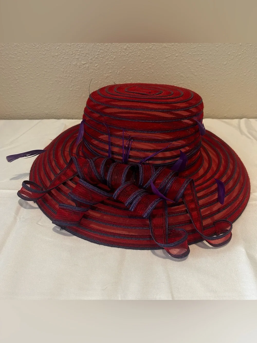Elegant Red Wide-Brim Dress Hat with Purple Feather Trim